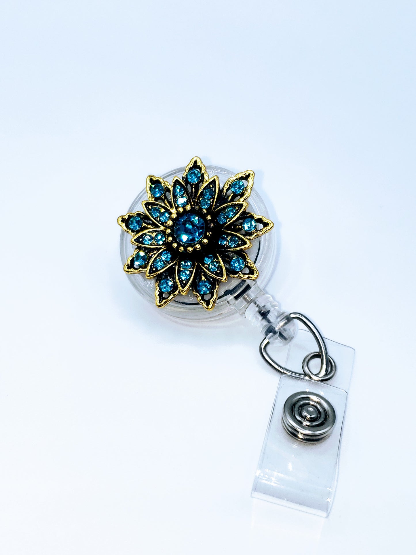 Teal blue rhinestones 32" retractable cord for quick swiping Spinning alligator clip back ID Pocket sold separately Handcrafted and assembled