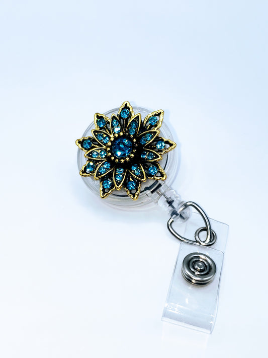 Teal blue rhinestones  32" retractable cord for quick swiping  Spinning alligator clip back  ID Pocket sold separately  Handcrafted and assembled